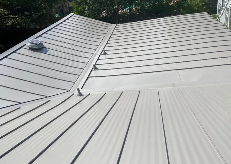 Solar attic fan installed on a metal roof for Roof Ventilation in Mayflower Village
